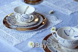 Porcelain set a golden dinner plate, a white starter plate, a tea pair